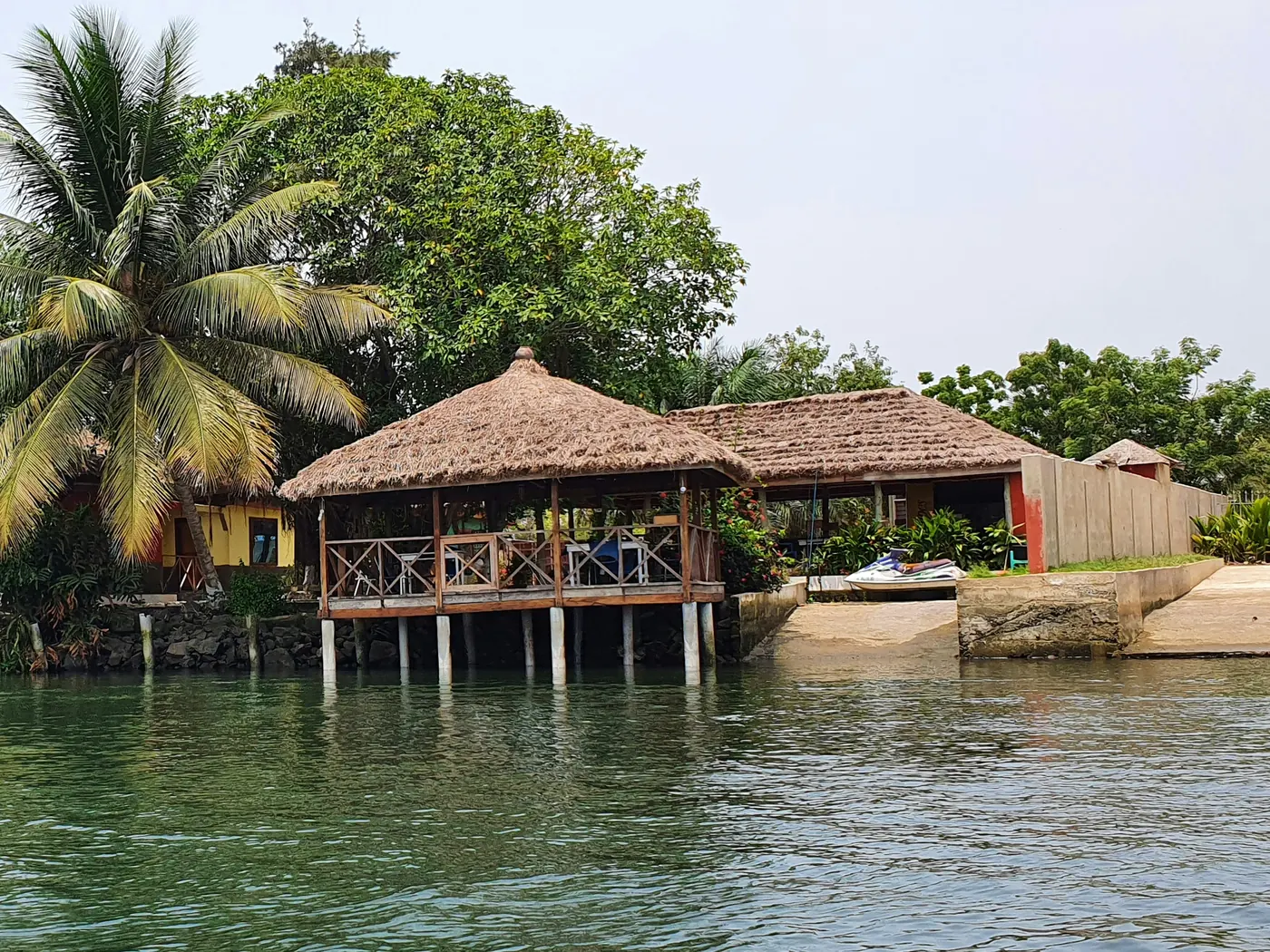 Thatched waterside restaurant deck on a lagoon in Ghana